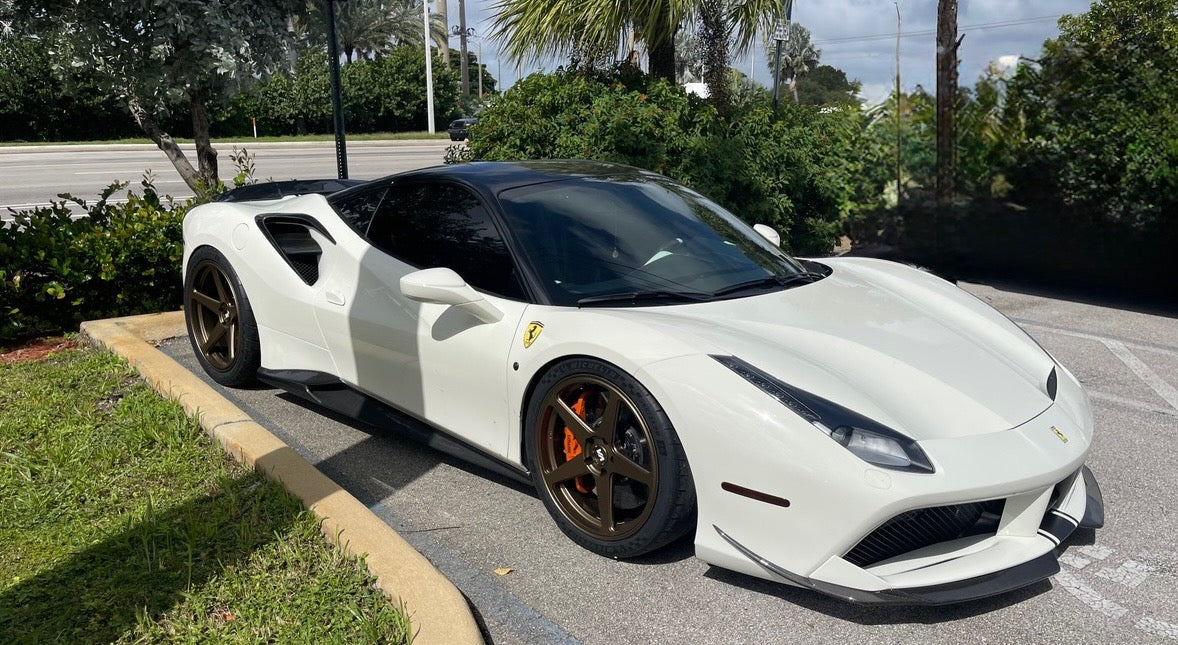 Front three-quarter view of a Ferrari 488 fitted with Satin Bronze Senas wheels in a double staggered fitment, highlighting the car’s sleek design and elegant wheel finish.