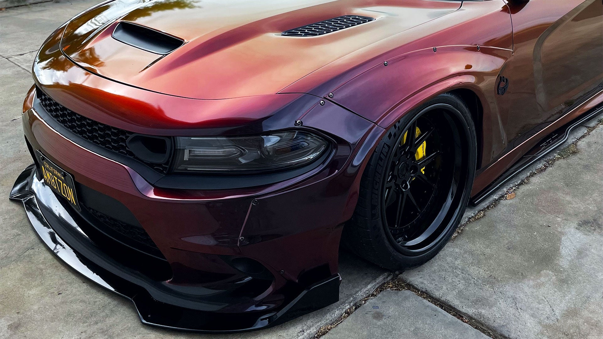 Custom widebody Dodge Charger with triple black CDM-3P wheels, highlighting aggressive front stance and sleek wheel finish.